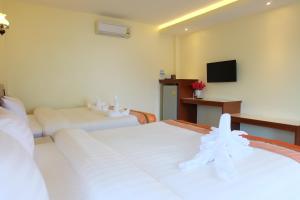 Postel nebo postele na pokoji v ubytování Chokdee Resort