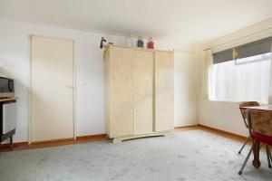 a room with a wooden cabinet and a window at Authentic Dutch Houseboat in Amsterdam Zuid in Amsterdam +9 photos