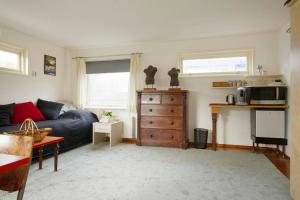 a living room with a couch and a microwave at Studio on a houseboat, near city centre! in Amsterdam