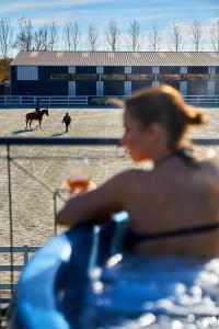 a woman in a bikini watching a horse race at Boutique Complex Trakiets in Duvanlii