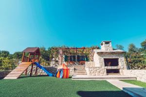 a playground with a slide and a play structure at Villa Zen Imotski in Zmijavci