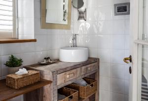 a bathroom with a wooden vanity with a sink at Hotel Les Bois Flottais in Le Bois-Plage-en-Ré