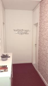 a bathroom with a wall with writing on the wall at 2G Apartments in Zagreb