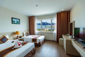 Postel nebo postele na pokoji v ubytování Halong Harbour Hotel