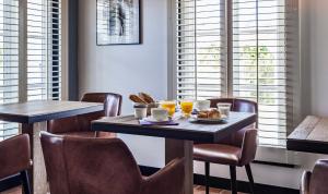 a dining room with a table with breakfast foods on it at Hotel Les Bois Flottais in Le Bois-Plage-en-Ré