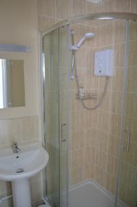 a bathroom with a shower and a sink at Claremont in Shanklin