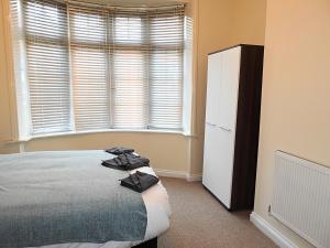 a bedroom with a bed and a white refrigerator at Parks Nest 1 in Hull