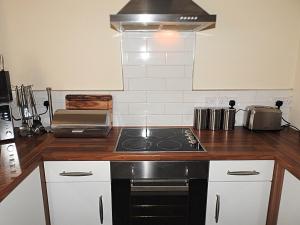 a kitchen with a stove top oven in a kitchen at Parks Nest 1 in Hull