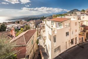 a large building with a view of the ocean at La Malandrina in Taormina