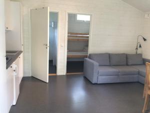 a living room with a couch and a kitchen at Eksjö Camping & Konferens in Eksjö +12 photos