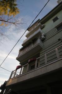 a building with a balcony on the side of it at Momo's studio apartment Subotica in Subotica
