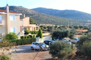 a group of cars parked in a parking lot at Helen's Sounio Apartments in Sounio