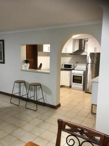 a kitchen with two stools and a counter in a room at SA house in Modbury