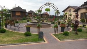 a park with a fountain and benches and plants at Amfora Hotel in Nakonechnoye
