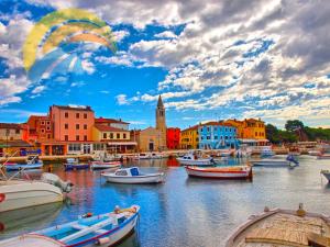 a group of boats docked in a harbor with buildings at Apartment Branka 1507 in Fažana