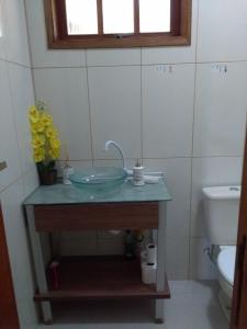 a bathroom with a sink and a toilet at Vivenda Cravo&Canela in Abraão