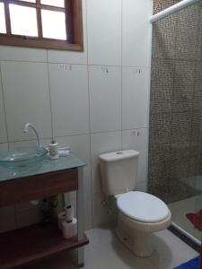 a bathroom with a toilet and a sink and a shower at Vivenda Cravo&Canela in Abraão +30 photos