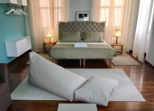 a bedroom with a king sized bed with a large pillow at Pep's Rooms by the sea in Trieste