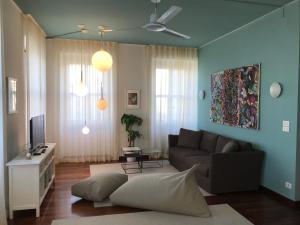 a living room with a couch and a tv at Pep's Rooms by the sea in Trieste