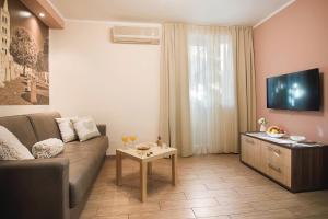 a living room with a couch and a table at Holiday Center Ivona in Zadar
