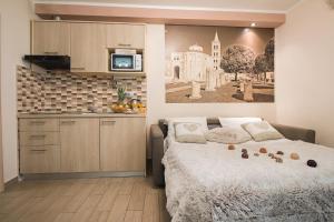 una cocina y una cama en una habitación pequeña en Holiday Center Ivona, en Zadar