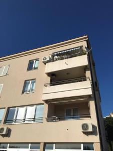 a tall building with balconies on the side of it at Apartment IRENA with Bikes included in Pula