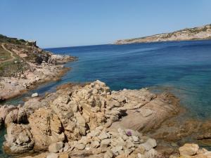 a group of rocks on the shore of the ocean at Bilocale Pascoli in Santa Teresa Gallura +6 photos