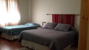 Postel nebo postele na pokoji v ubytování La Casa de Carlitos