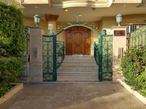 an entrance to a house with a wooden door at Choueifat Residence Families Only in Cairo