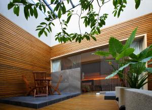 a patio with chairs and a table in a house at Spring SPA Motel 大里春天泡湯旅館 in Dali