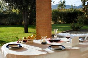 a white table with glasses of wine on it at Agriturismo Bocci in Castiglione della Pescaia