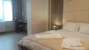 une chambre d'hôtel avec un lit et 2 serviettes. dans l'établissement Guesthouse Nikolić, à Negotin