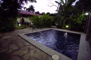 a swimming pool in a backyard at night at Hotel Casa Colonial Boutique in Managua