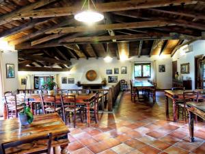 a dining room with wooden tables and chairs at Agriturismo Sa Mendhula in Cugnana