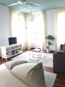 a living room with two beds and a couch at Pep's Rooms by the sea in Trieste