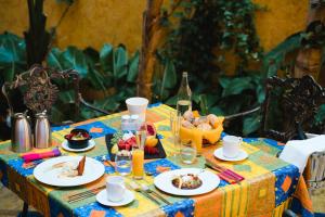 a table with plates of food and a bottle of wine at Europe Villa Cortes GL in Playa de las Americas