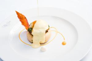 a dessert on a plate with an umbrella on it at Europe Villa Cortes GL in Playa de las Americas