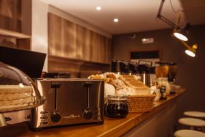 a counter top with bread and a toaster on it at Eco Hostel in Catania