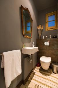 a bathroom with a sink and a toilet and a mirror at Barcelona 54 Apartment Rentals in Barcelona