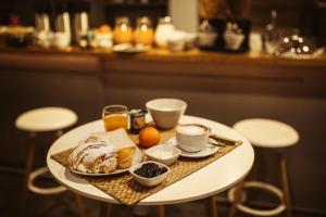 a table with a tray of breakfast food on it at Eco Hostel in Catania