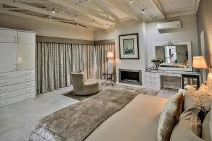 a living room with a couch and a fireplace at Sea Dreams Guesthouse in Ballito +27 photos