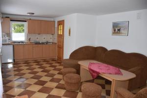 a kitchen with a table and chairs and a checkerboard floor at KÓŃSKO SIGŁA in Wisła