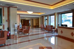 a lobby with chairs and a bar in a building at Palace Hotel Legnano in Legnano