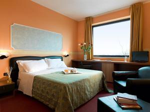 Postel nebo postele na pokoji v ubytování Hotel Bifi