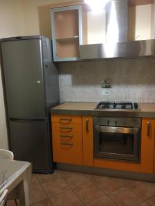 a kitchen with a stove and a refrigerator at Residence K.B. 2 in Fano