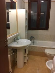 a bathroom with a sink and a tub and a toilet at Residence K.B. 2 in Fano +21 photos