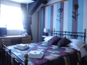 Postel nebo postele na pokoji v ubytování Belle Vue Hotel