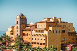 a tall building with a clock tower on top of it at Europe Villa Cortes GL in Playa de las Americas