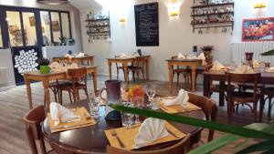 a restaurant with wooden tables and chairs in a room at Ferme Auberge Linossier in Burdignes +18 photos