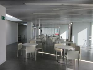 a dining area with tables and chairs in a building at UBA Hostel in San Sebastián